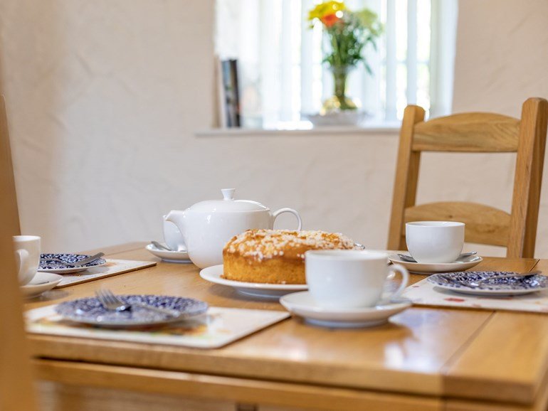 Cream tea and cake on the cottage table