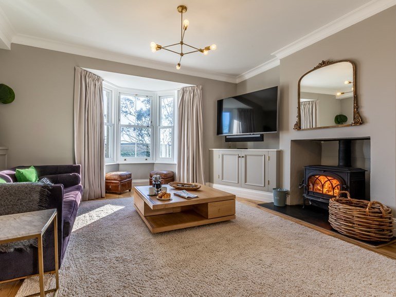 Lounge with wood burner and gilt mirror