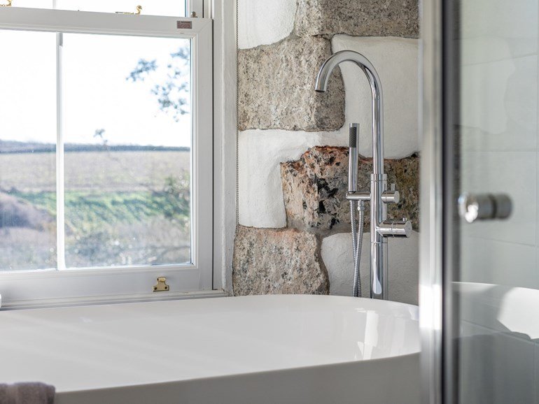 Freestanding bath with countryside views