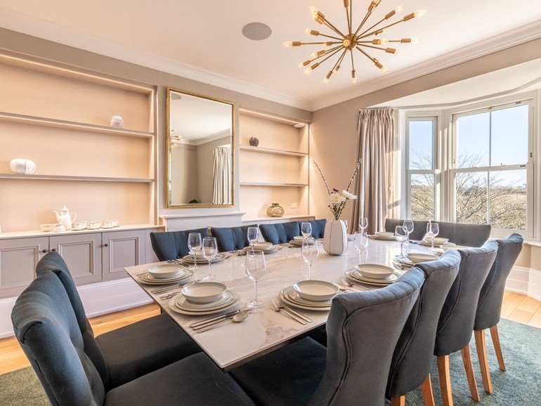 Dining room with marble table seating twelve