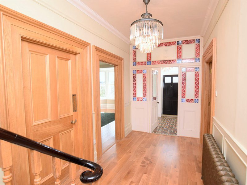 Victorian tiled hallway with chandelier