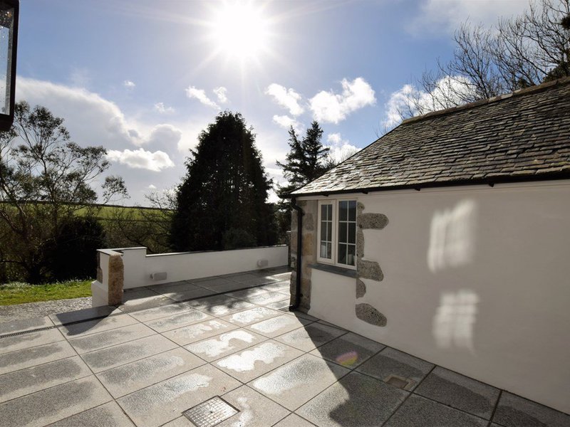 Sun-drenched patio beside one of the converted cottages