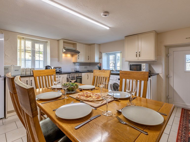 Kitchen and dining table laid for six